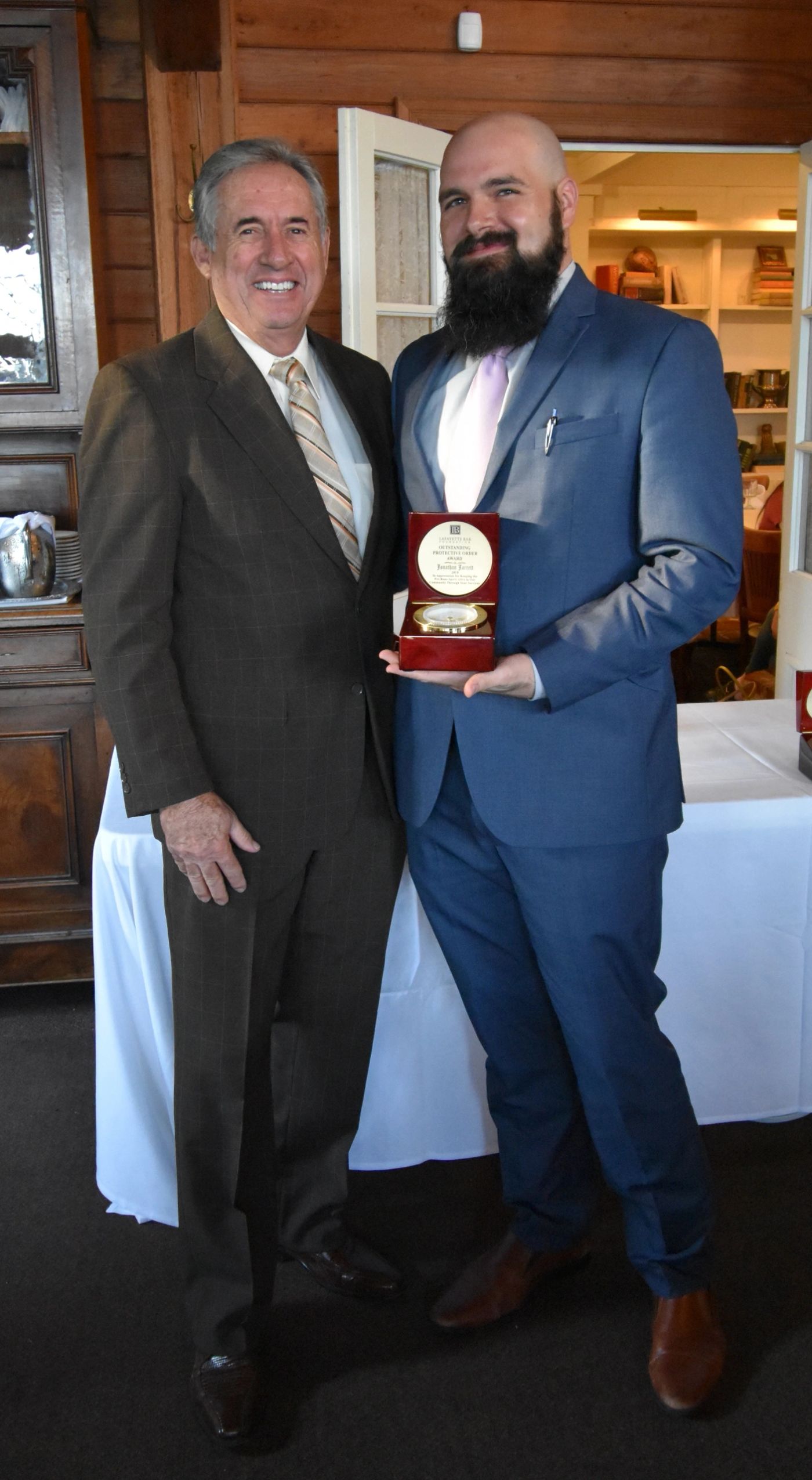 Jonathan Jarrett receiving an award with Justice James Genovese, Louisiana Supreme Court